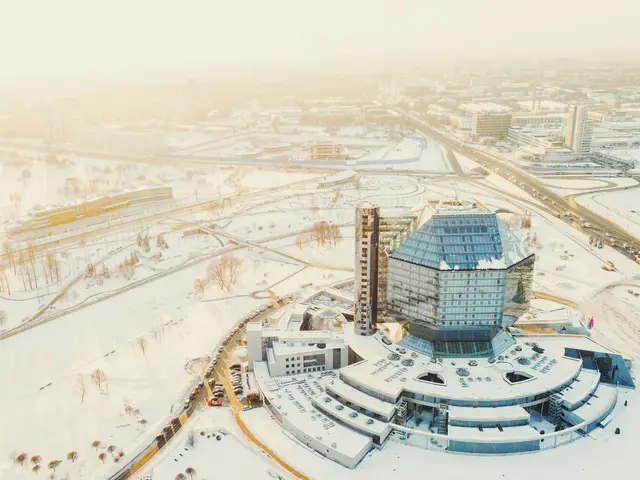 Aerial view of the National Library's glass diamond surrounded by snow in soft winter light